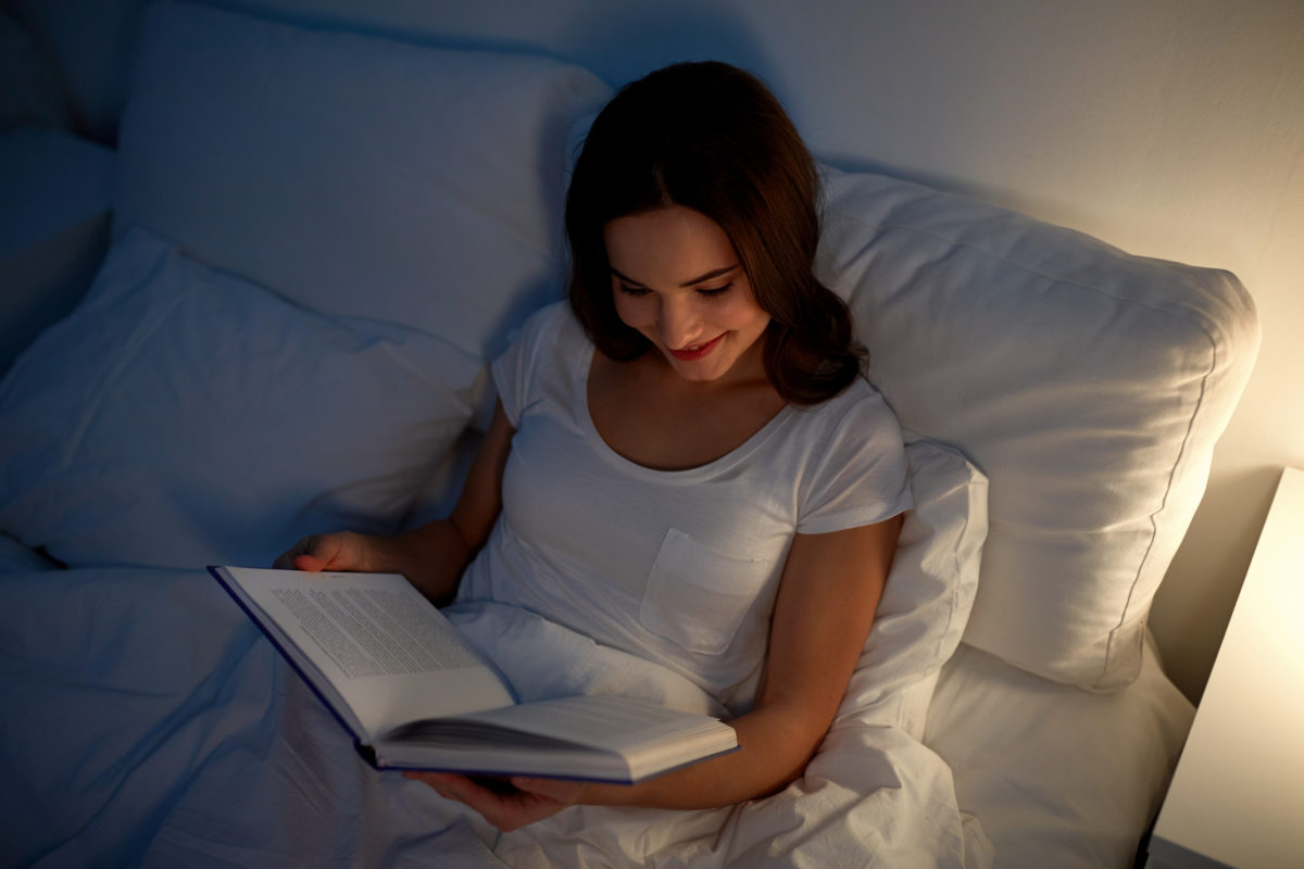 reading book in bed to improve sleep